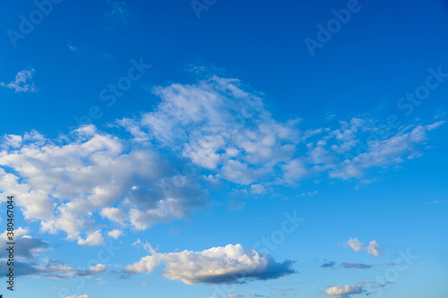  Cloudy sky with a parts of clear blue sky on a sunset. Natural background.