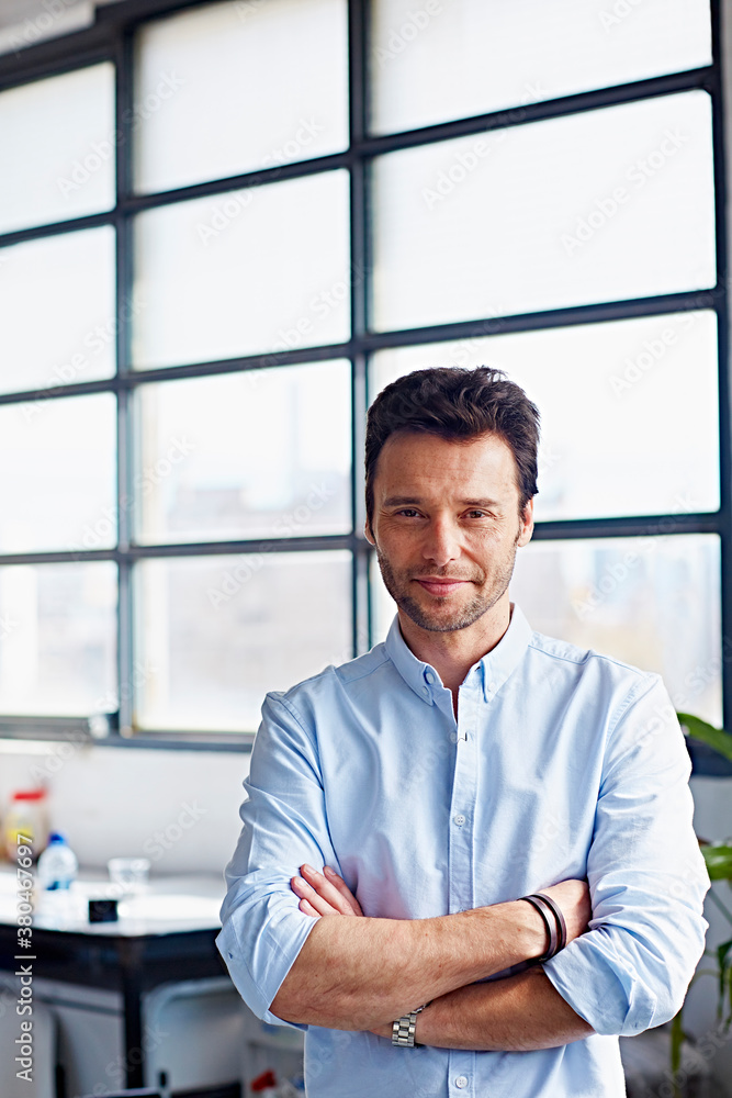 Businessman Standing Arms Crossed In Office Businessman Standing Arms Crossed In Office