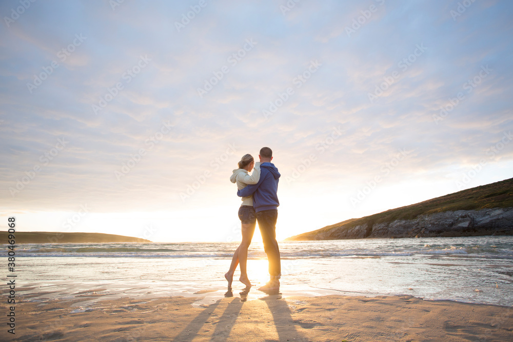 Loving couple on beach at sunset. Loving couple on beach at sunset.
