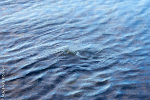 Blurred waving water surface as a natural background.