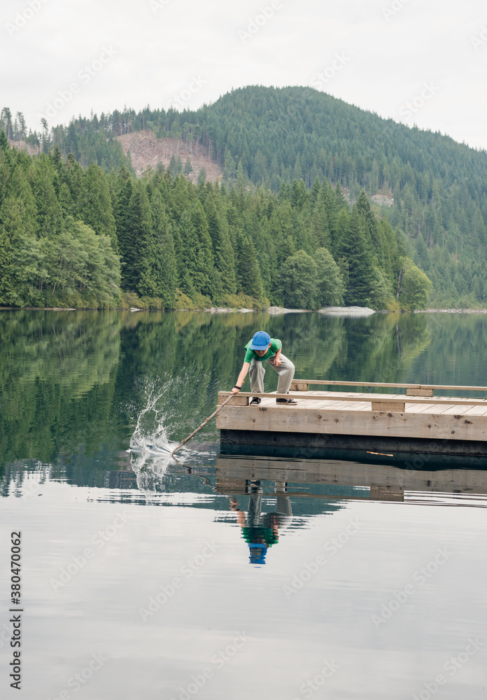 Boy Playing With Stick In Water Boy Playing With Stick In Water