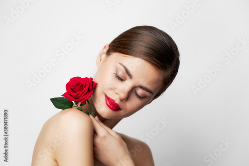 Portrait of woman with rose Eyes closed red lips 