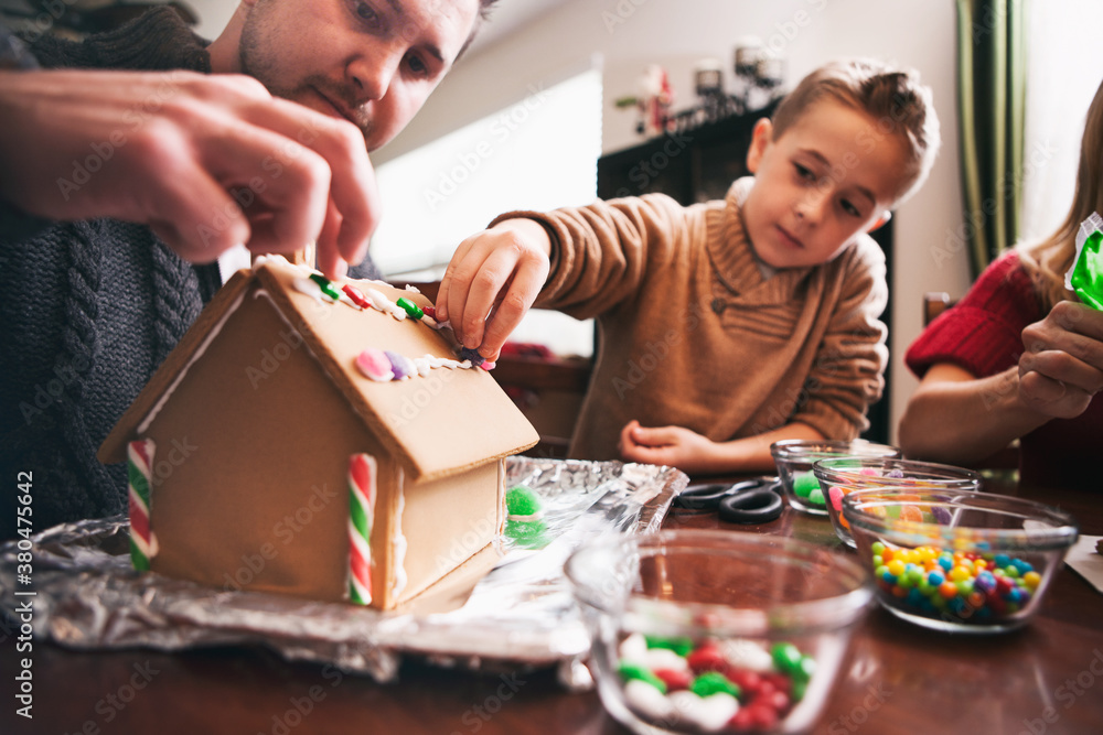 Christmas: Father And Son Working On Gingerbread House Christmas: Father And Son Working On Gingerbread House