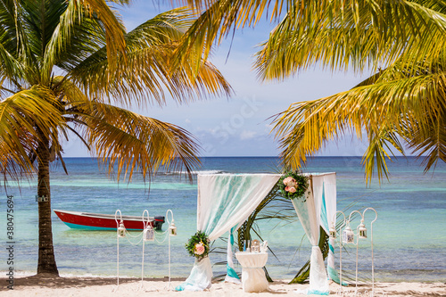 Obraz na plátně Wedding bamboo gazebo, decorated with tropical flowers and coloured fabrics on t