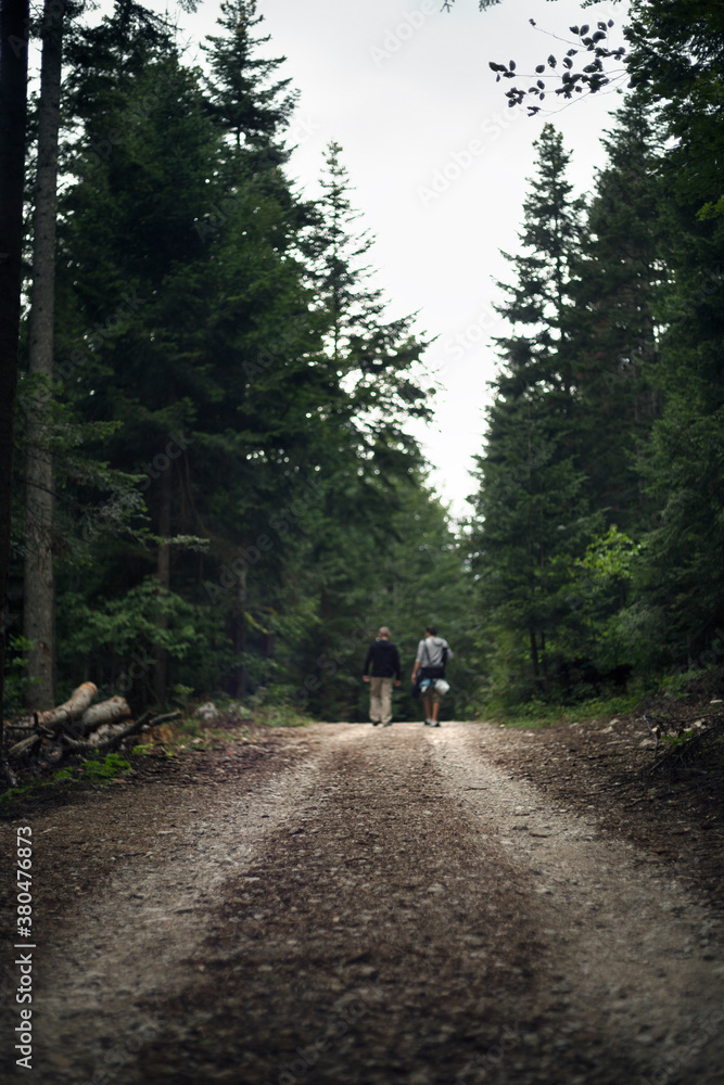 Two man walking trough the woods