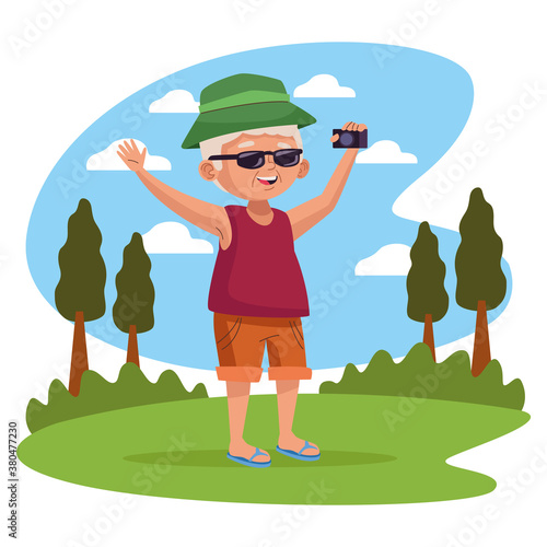 old man with camera photographic in the park active senior