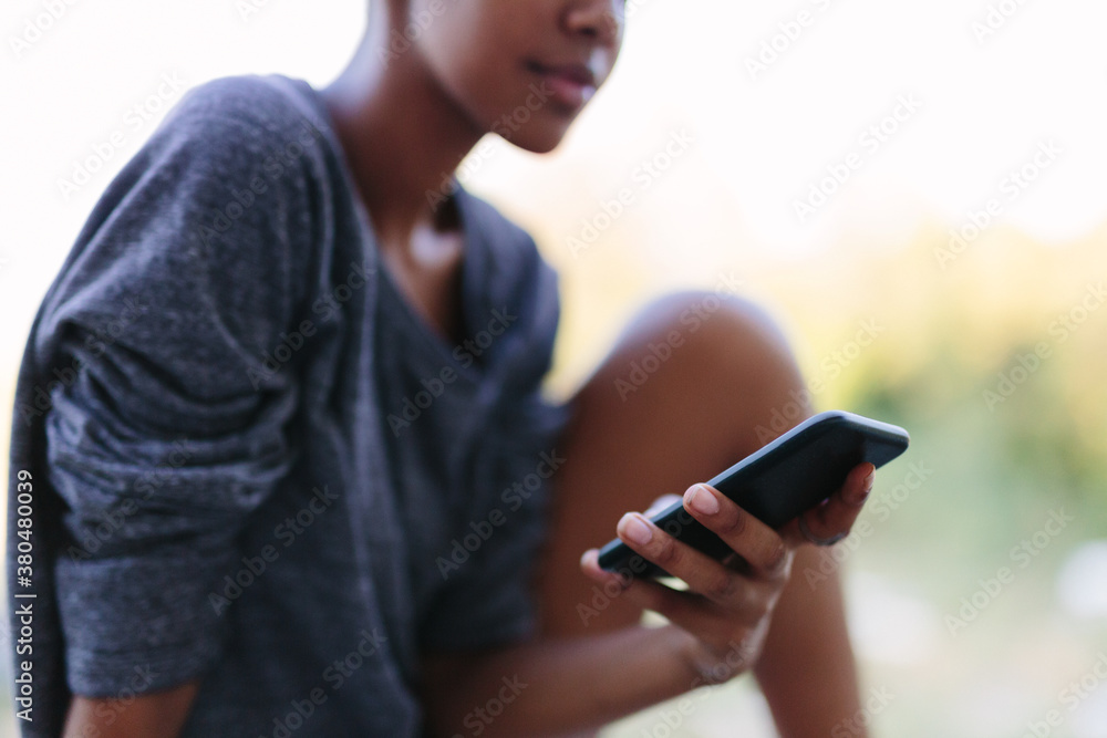 Black woman with dreadlocks checking the cell phone Black woman with dreadlocks checking the cell phone