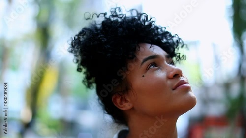 Young black woman looking up to sky with hope and faith photo