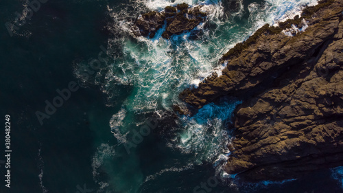 The aerial view of raging ocean and fantastic rocky coast.