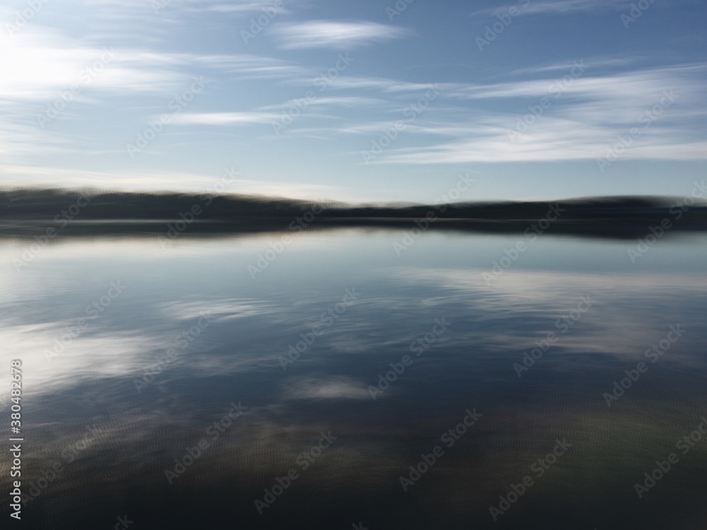 Movement shot of a river with cloud reflections on water Movement shot of a river with cloud reflections on water
