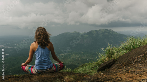 Meditating on the top of mountain in tropics photo