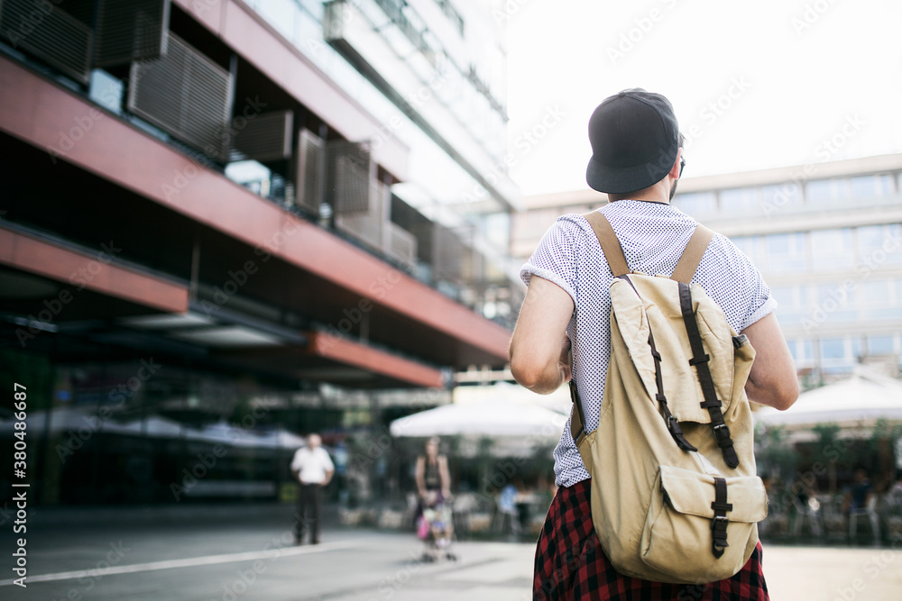 A man from the back with a rucksack A man from the back with a rucksack