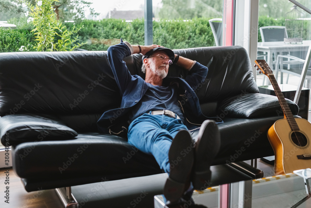 Happy and serene senior man relaxing at home Happy and serene senior man relaxing at home