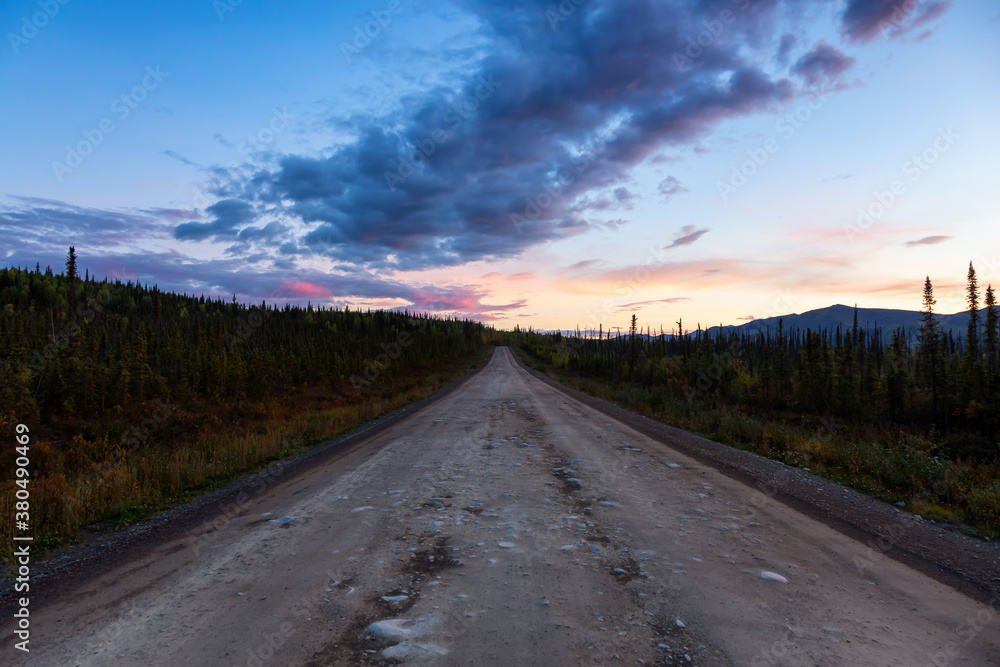 View of Scenic Road leading to Tombstone at Sunrise in Canadian Nature. Dempster Highway, Yukon, Canada.