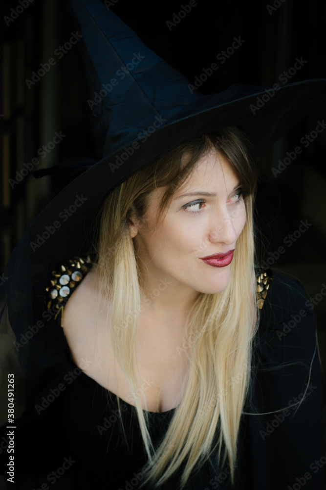 Portrait of a blonde female model costume as witch