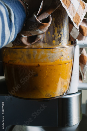 Closeup of a blender blitzing a soup. photo