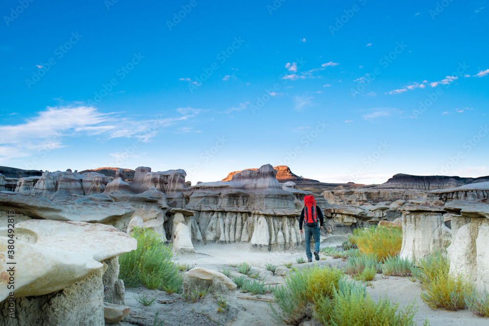 Backpacker Hiking in Bisti Badlands Wilderness Area New Mexico at First Light Backpacker Hiking in Bisti Badlands Wilderness Area New Mexico at First Light