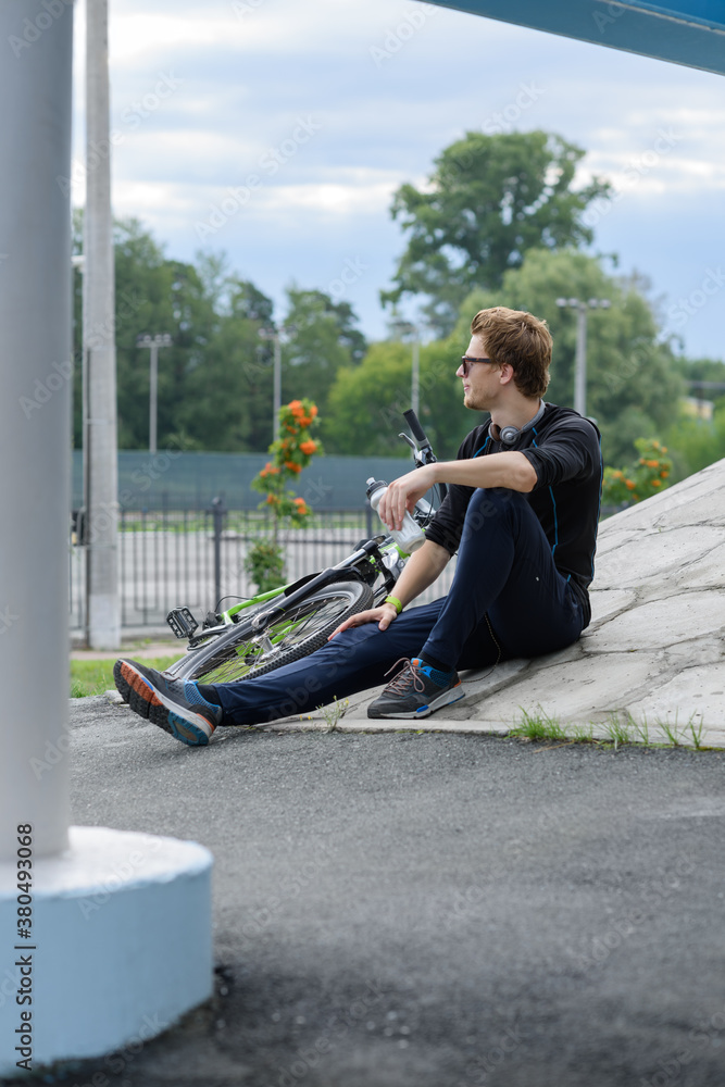 Man resting near bike