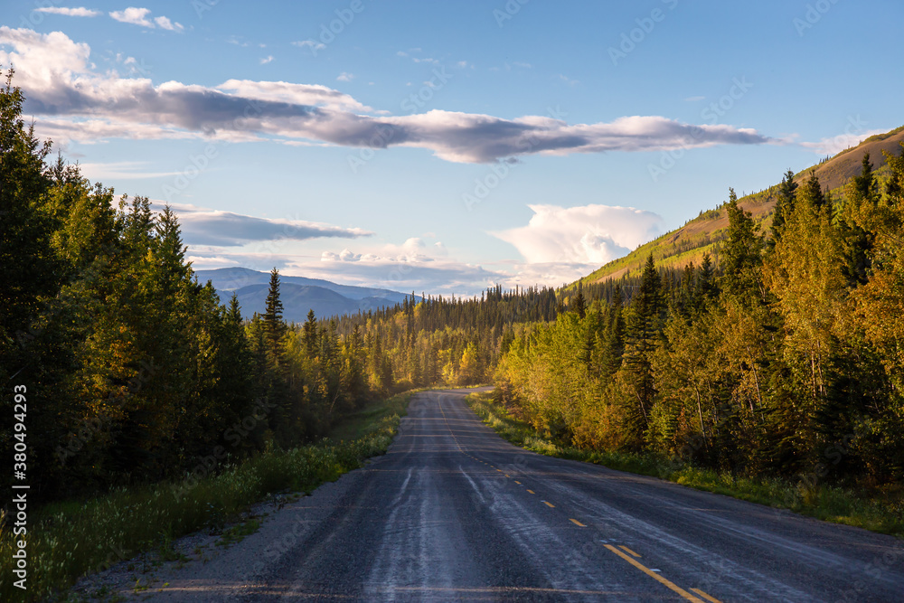 Scenic Road View of Klondike Hwy during a sunny and colorful sunset. Taken North of Whitehorse, Yukon, Canada.