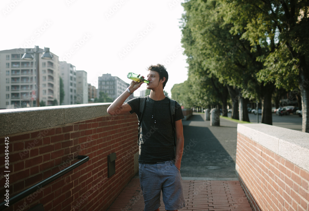 Young man drinking a beer outdoors Young man drinking a beer outdoors