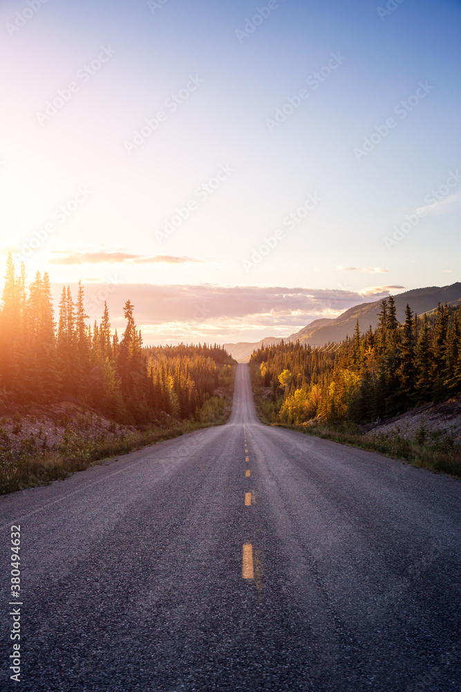 Scenic Road View of Klondike Hwy during a sunny and colorful sunset. Taken North of Whitehorse, Yukon, Canada. Scenic Road View of Klondike Hwy during a sunny and colorful sunset. Taken North of Whitehorse, Yukon, Canada.