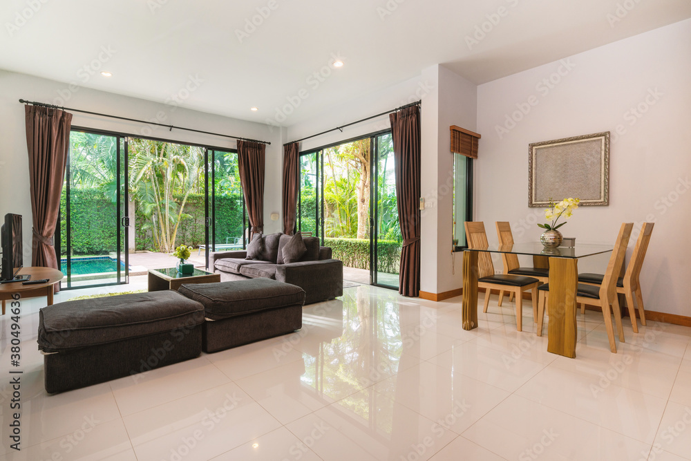 Fototapeta premium Interior design of house, home and villa feature sofa, dining table, chair, sliding door and curtain in living room with pool view