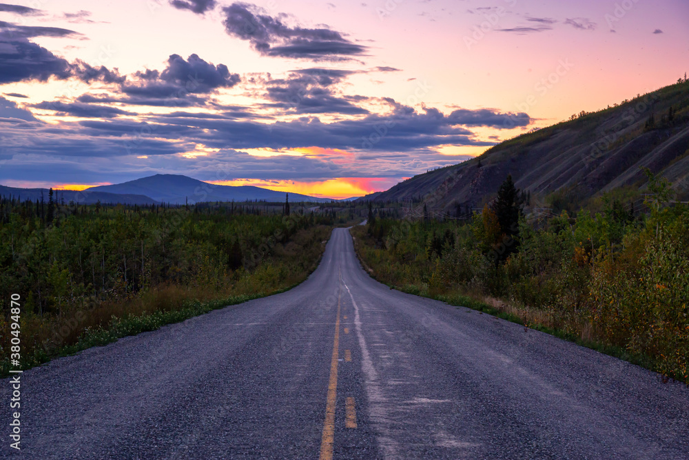 Scenic Road View of Klondike Hwy during a sunny and colorful sunset. Taken North of Whitehorse, Yukon, Canada.