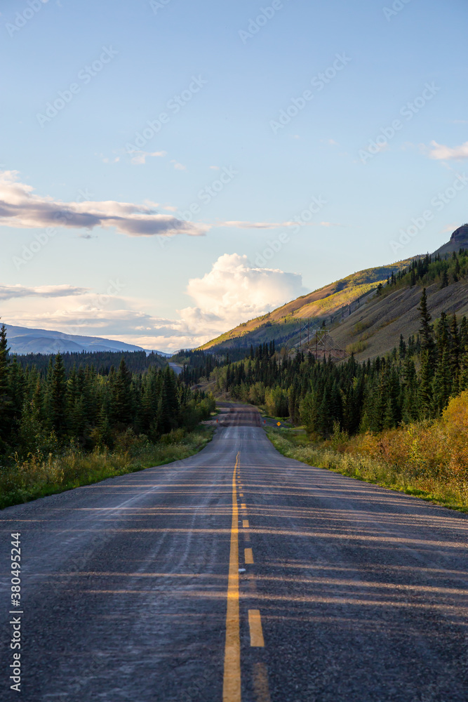 Fototapeta premium Scenic Road View of Klondike Hwy during a sunny and colorful sunset. Taken North of Whitehorse, Yukon, Canada.