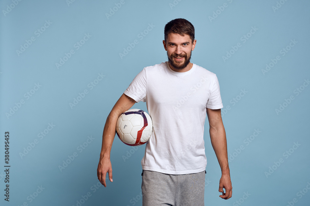 male coach with soccer ball on blue background cropped view Copy Space
