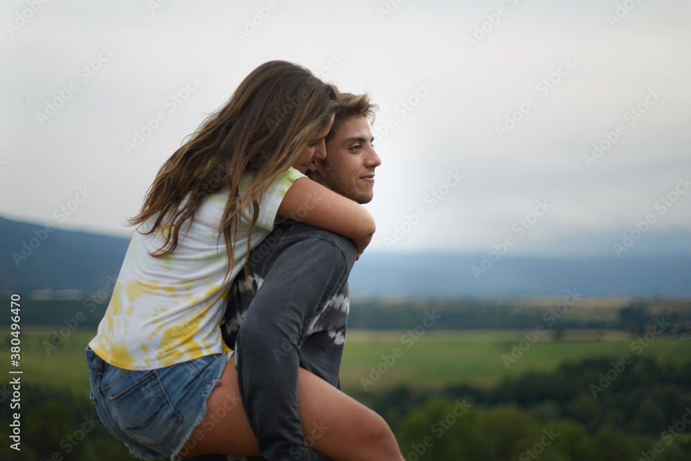 Young couple of teenagers enjoying and embracing outdoors Young couple of teenagers enjoying and embracing outdoors