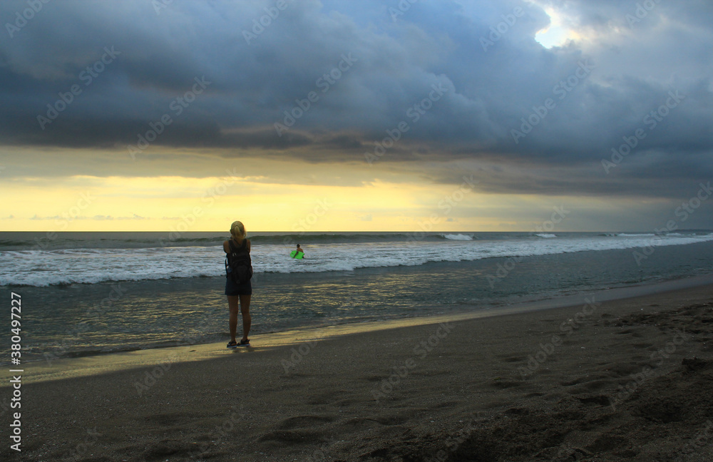 A woman take a photo at Petitenget beach Bali Indonesia