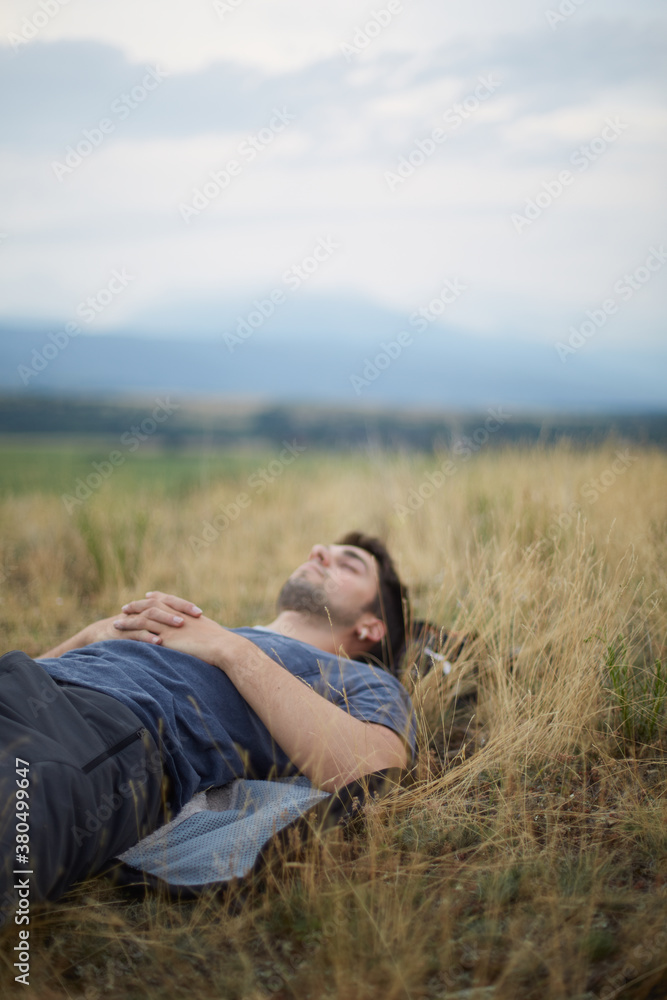 Young man taking a rest on the grass of a field Young man taking a rest on the grass of a field