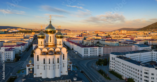 Beautiful morning panorama of the city of Magadan. Aerial view of the cathedral  streets and buildings illuminated by the sun at sunrise. Trinity Cathedral  Magadan  Magadan Region  Far East Russia.