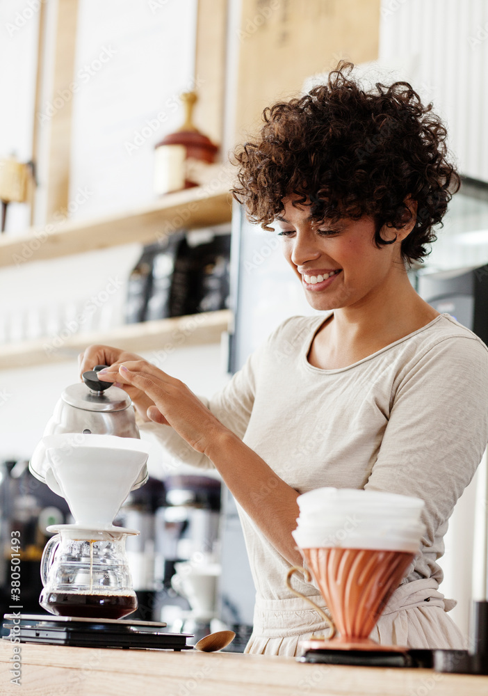 Beautiful barista brewing a specialty drip coffee. Beautiful barista brewing a specialty drip coffee.