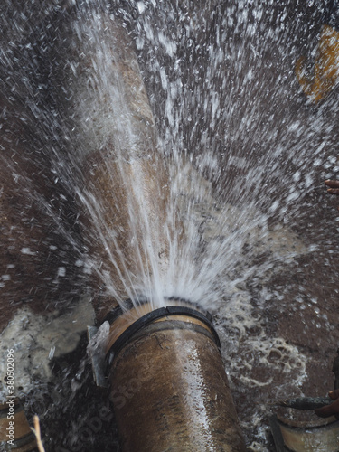 Splashing water from burst pipe