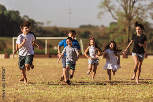 Children on soccer field running and playing
