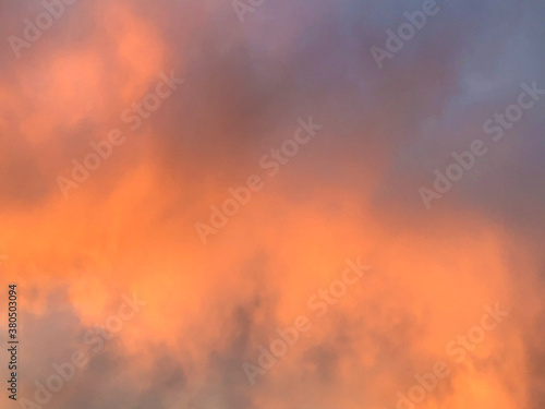 Dramatic sunset or sunrise sky with orange and purple clouds © MizC