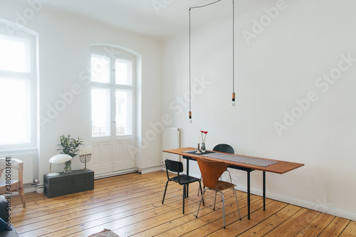 Wooden Table and Chairs in Bright White Minimalist Living Room photo