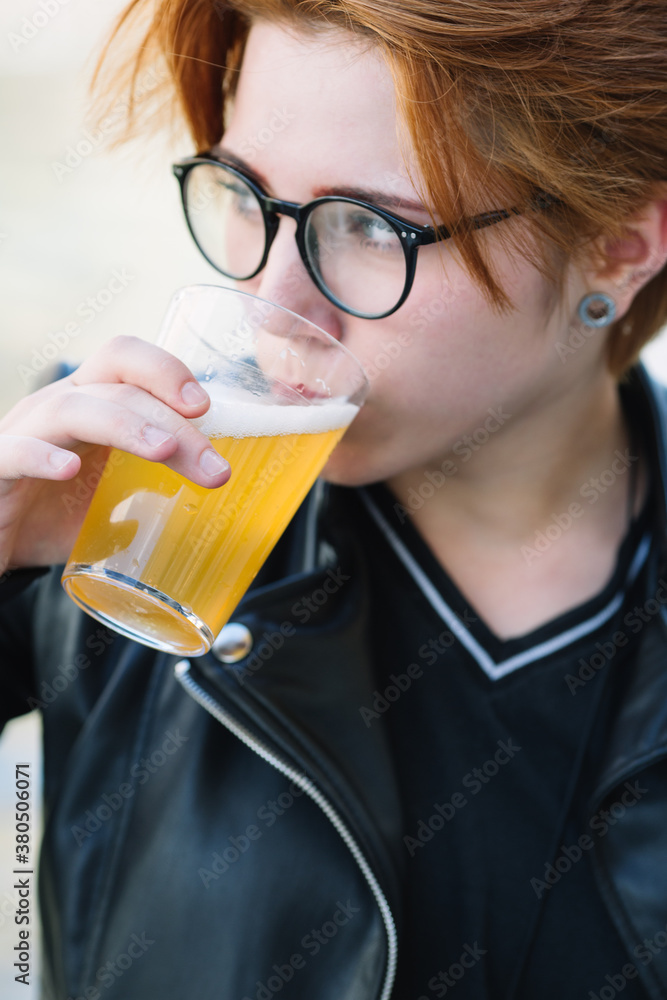 Young woman holding a glass of beer Young woman holding a glass of beer