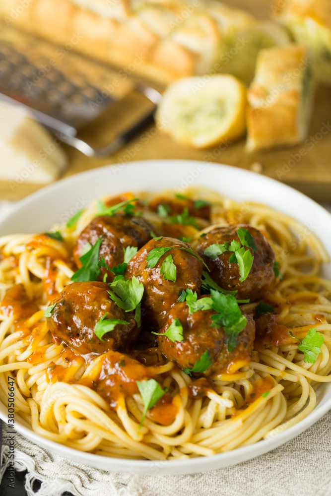 Beef meatballs on spaghetti with flat leaf parsley Beef meatballs on spaghetti with flat leaf parsley