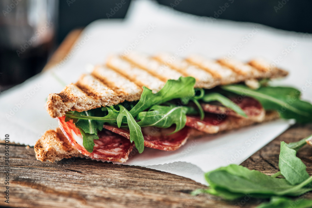 Food: Grilled sandwich with salami and rocket salad Food: Grilled sandwich with salami and rocket salad