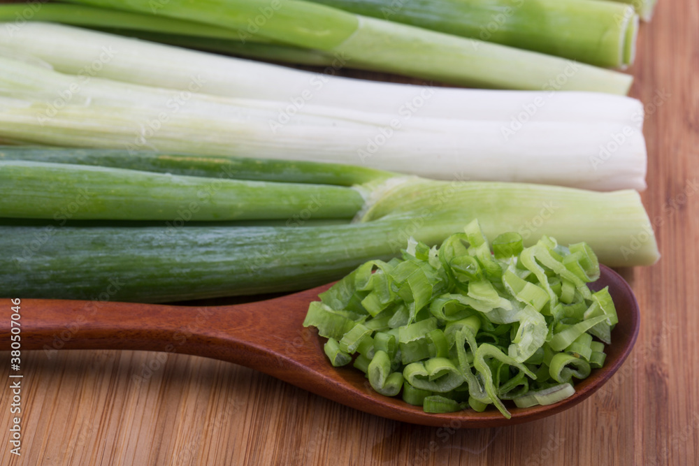 Obraz premium close up image of chopped spring green onions on a white background.