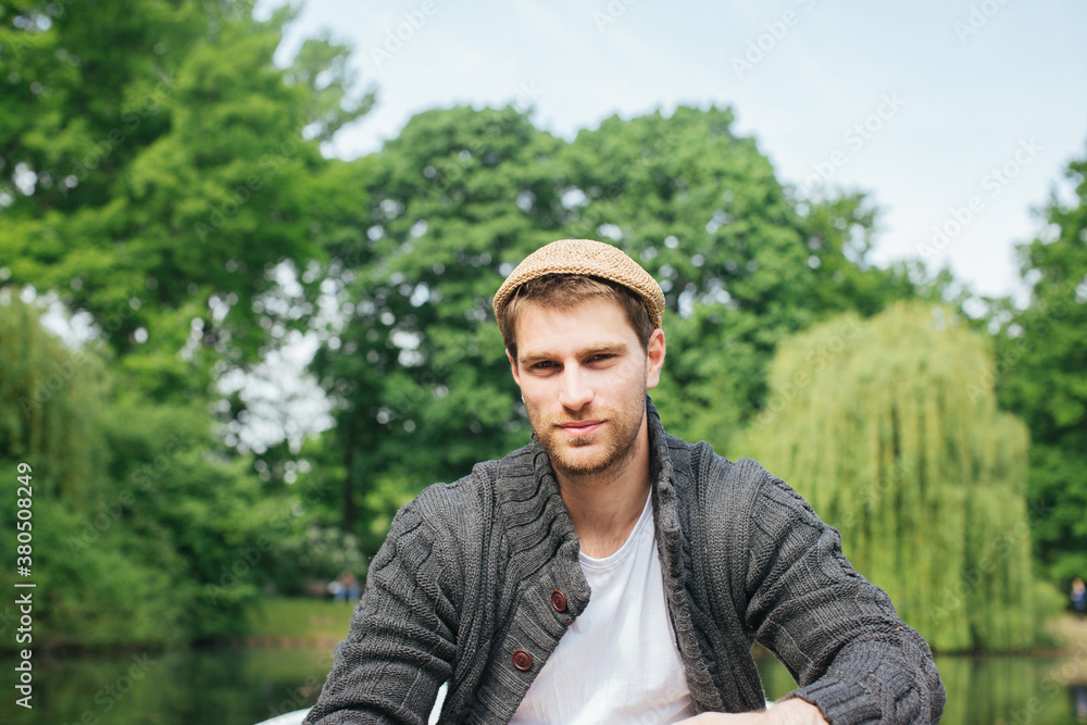 Portrait of Good-Looking Caucasian Man Sitting in Rowboat on Sunny Day Portrait of Good-Looking Caucasian Man Sitting in Rowboat on Sunny Day