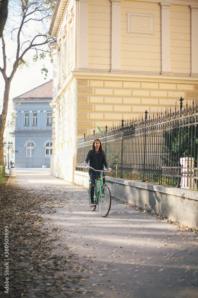 Young urban woman riding a bicycle in the city Young urban woman riding a bicycle in the city