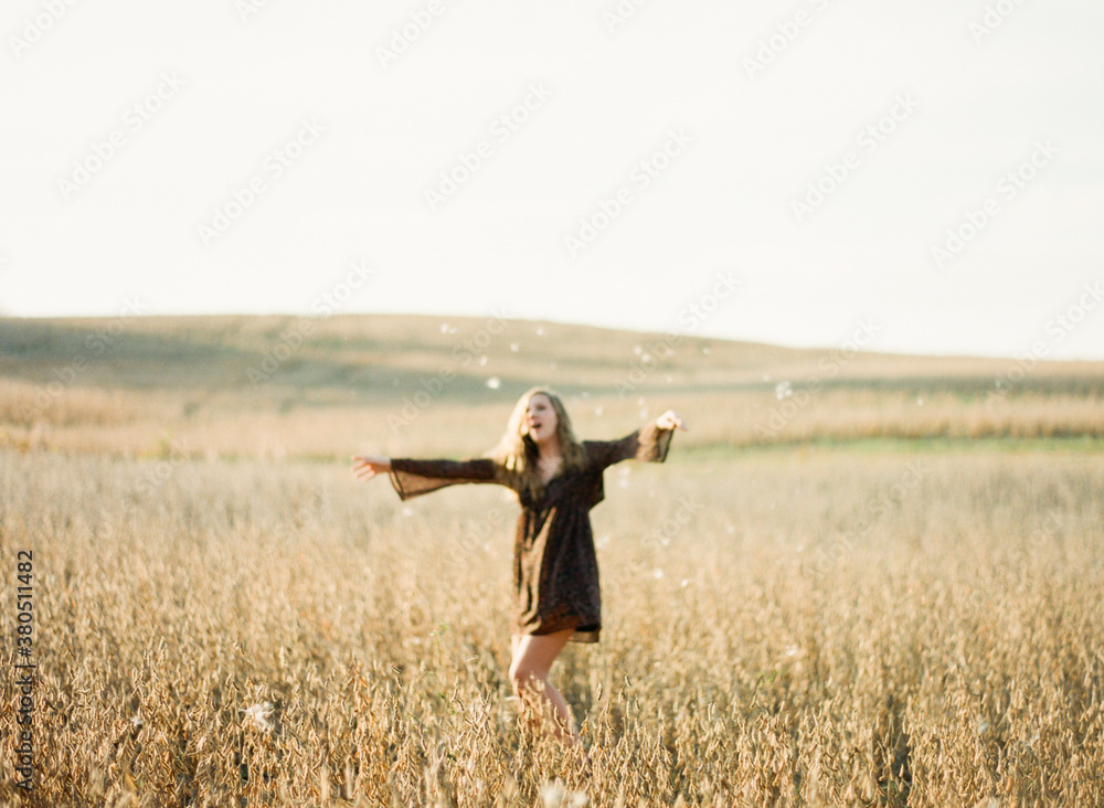 Girl playing a soy field with seed fluff Girl playing a soy field with seed fluff