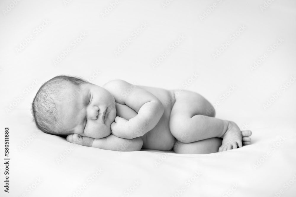 Newborn Baby Girl Sleeping Peacefully in Fetal Position Stock Photo