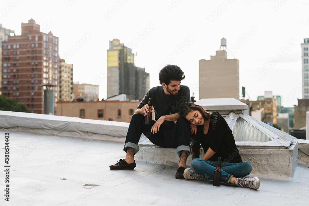 Young couple having fun on a rooftop in the city Young couple having fun on a rooftop in the city