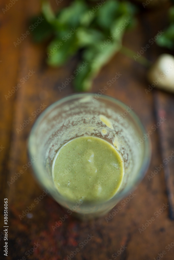Healthy green smoothie on cracked wooden table Healthy green smoothie on cracked wooden table