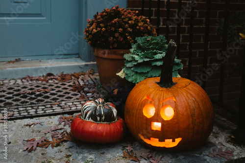 Lit Jack-O-Lantern on the front stoop photo