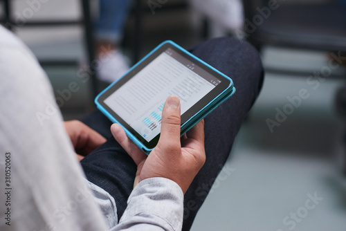 Young man researching newsworthy information on digital tablet photo